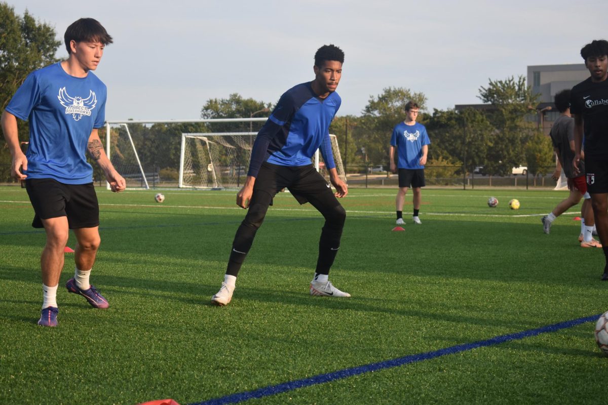 Student Government Association President Jayeim Blake, center, plays goalkeeper for men's soccer