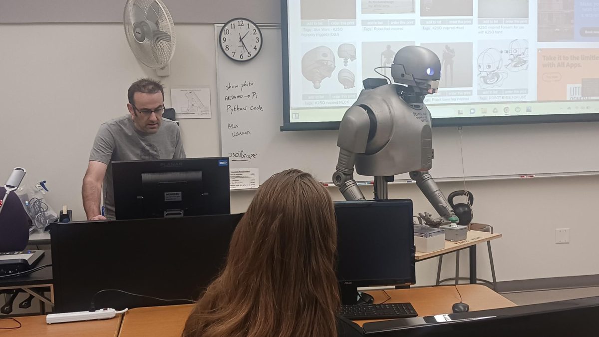 Professor Tim Callinan presents the robot K-2SO at a guest speaker event.