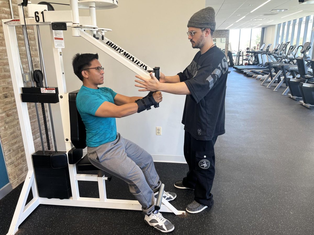 Third-year student Aidan Gamache (right) and Fitness Center employee John Lorenzana start a club to help students reach fitness goals.