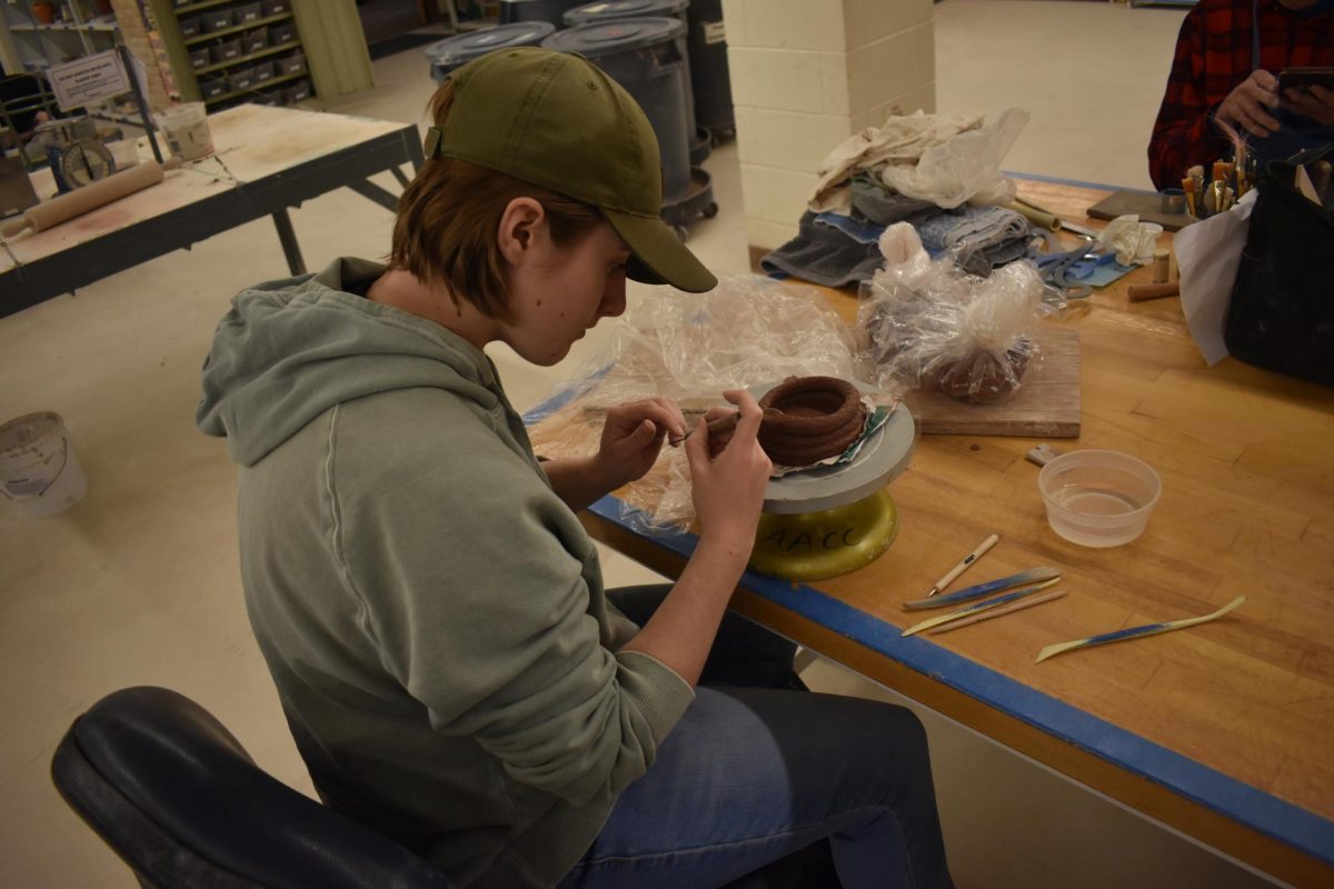 Sculpting student Dylan Kirkpatrick works on a piece inspired by the poem of another student, whose identity Kirkpatrick does not know.