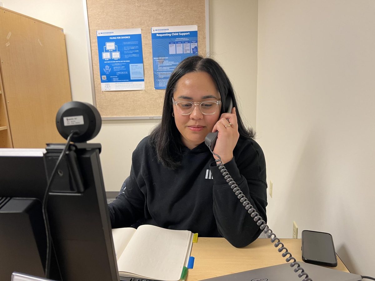 Felicia Tiumalu, a first-year transfer studies student, answers a call made to AACC’s legal self-help clinic.