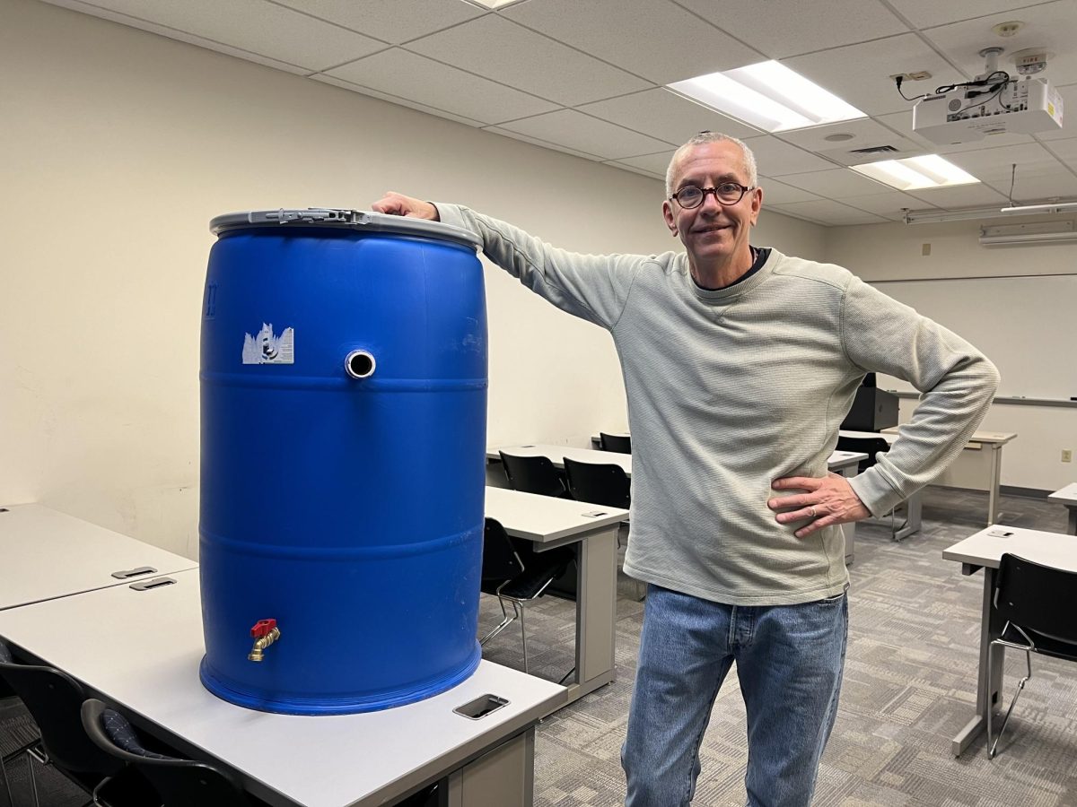 Business professor Shad Ewart accepts donations of rainwater barrels for his students to sell.